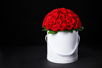 Romantic red roses in a white gift box to place the logo on a black background studio,spring is coming,international women's day - 103653531