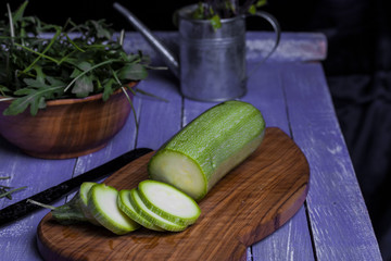zucchini sliced on wooden chopping board