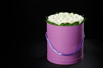 Romantic white roses in a round purple gift box to place the logo on a black background, studio shooting,spring is coming,international women's day