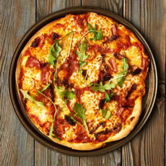 Home made pizza on wooden table