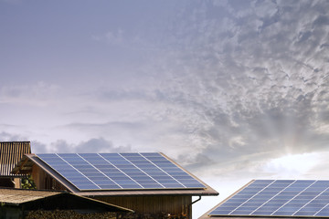 Solarzelle auf einem Holz Chalet Dach und Himmel Hintergrund mit Sonne und Sonnenstrahlen,