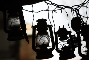  background of many lit storm lanterns or hurricane lamps