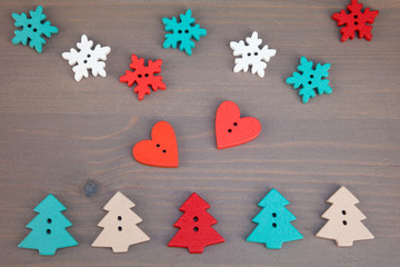 Red hearts, trees and snowflakes on grey wooden background. Button love. Wooden buttons. Post card for the Valentine. Valentine's Day postcard.