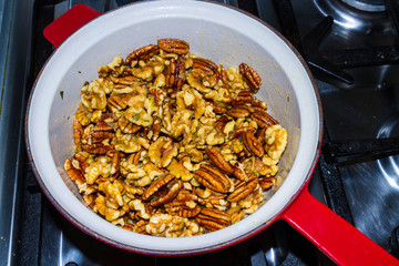 Mix nuts covered in butter garlic and rosemary mixture before ro
