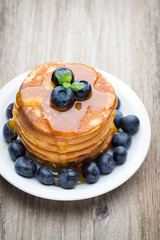Stack of pancakes with blueberry and fresh berry.