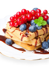 Homemade  waffles with chocolate sauce and berries isolated