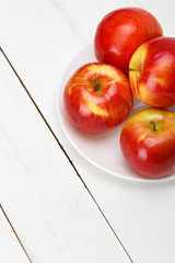 Red apples on a white table