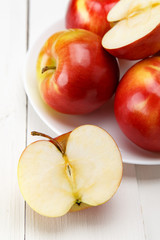 Naklejka na ściany i meble Red apples on a white table