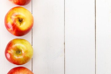 Red apples on a white table
