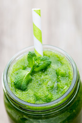 Rucola smoothie, on the grey  background.