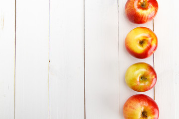 Red apples on a white table