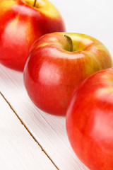 Red apples on a white table