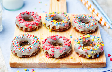 banana Donuts with icing and colorful sprinkles