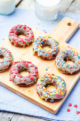 banana Donuts with icing and colorful sprinkles