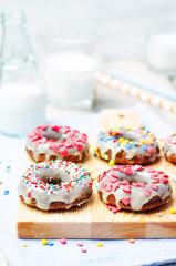 banana Donuts with icing and colorful sprinkles