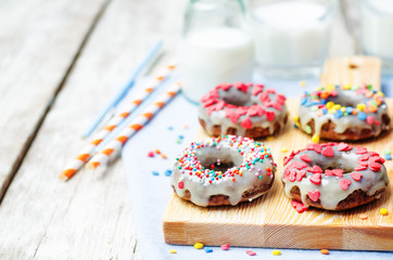 banana Donuts with icing and colorful sprinkles