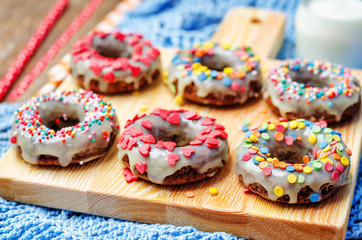 banana Donuts with icing and colorful sprinkles