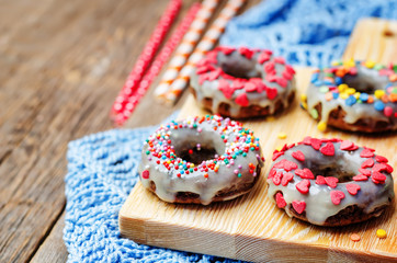 banana Donuts with icing and colorful sprinkles
