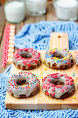 banana Donuts with icing and colorful sprinkles