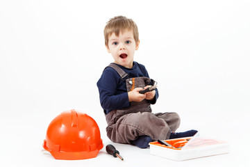 Funny little boy with tools kit on white background