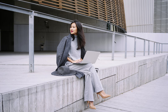 Beautiful Young Asian Business Woman Working Next To The Business Center During Lunch Break