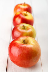 Свежие яблоки на белом деревянном столе