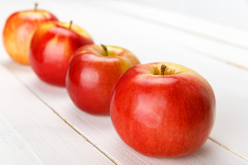 Fresh apples on a white wooden table