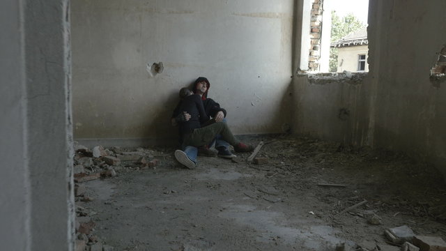 Depressed young couple sitting in an abandoned building