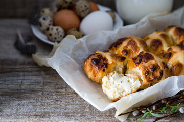 Easter hot cross buns with eggs rustic wood background