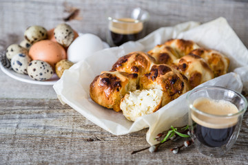 Easter hot cross buns with eggs rustic wood background