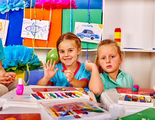 Fototapeta premium Two nice girl mold from plasticine in kindergarten .