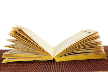 Open old book isolated on white background