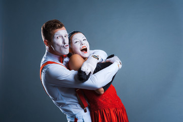  two funny mimes isolated on gray background