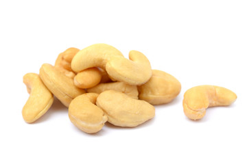 Tasty salted cashew nuts on a white background