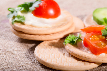 Cheese, tomatoes and greens of parsley on a napkin from a sackin