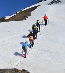 People hiking  on snow , Svaneti landscape in Georgia