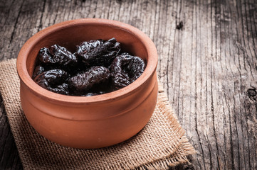 Dried plums rustic wooden background