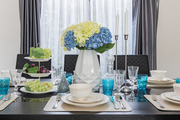 modern dinning room with table set on glass table