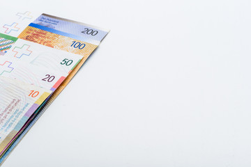 Suisse Francs Bills on White Table with Copy Space