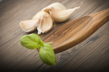 spoon of olive wood with basil leaves