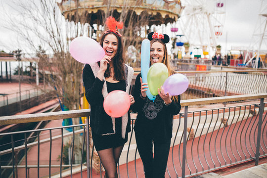 Two girls having fun at an amusement park
