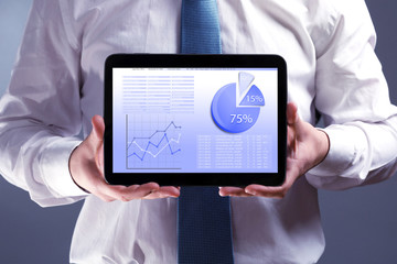 Businessman holding tablet-pc with scheme on screen