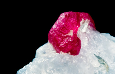 Raw uncut Ruby gem matrix stone isolated on black