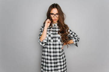 Portrait of cute teen girl wearing stylish shirt isolated on gray background fashion for teenagers