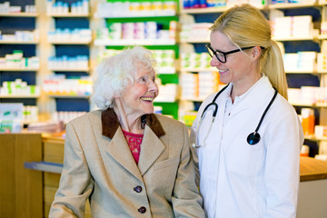 Elderly patient happy with her smiling doctor.