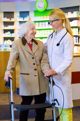 Friendly doctor with patient using walker.