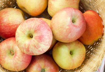 Fresh and colorful apples in basket, selective focus