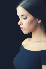 Portrait of beautiful elegant young woman isolated on black
