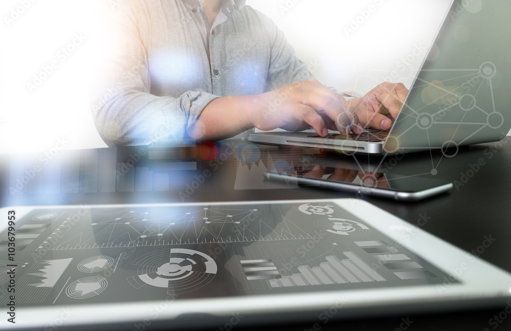 Wall mural designer working digital tablet and computer laptop with smart p
