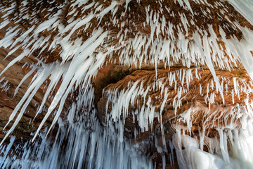 Windswept icicles hang from shoreline sandstone formations on Wisconsin's Apostle Islands National Lakeshore near Meyer's beach; Lake Superior.